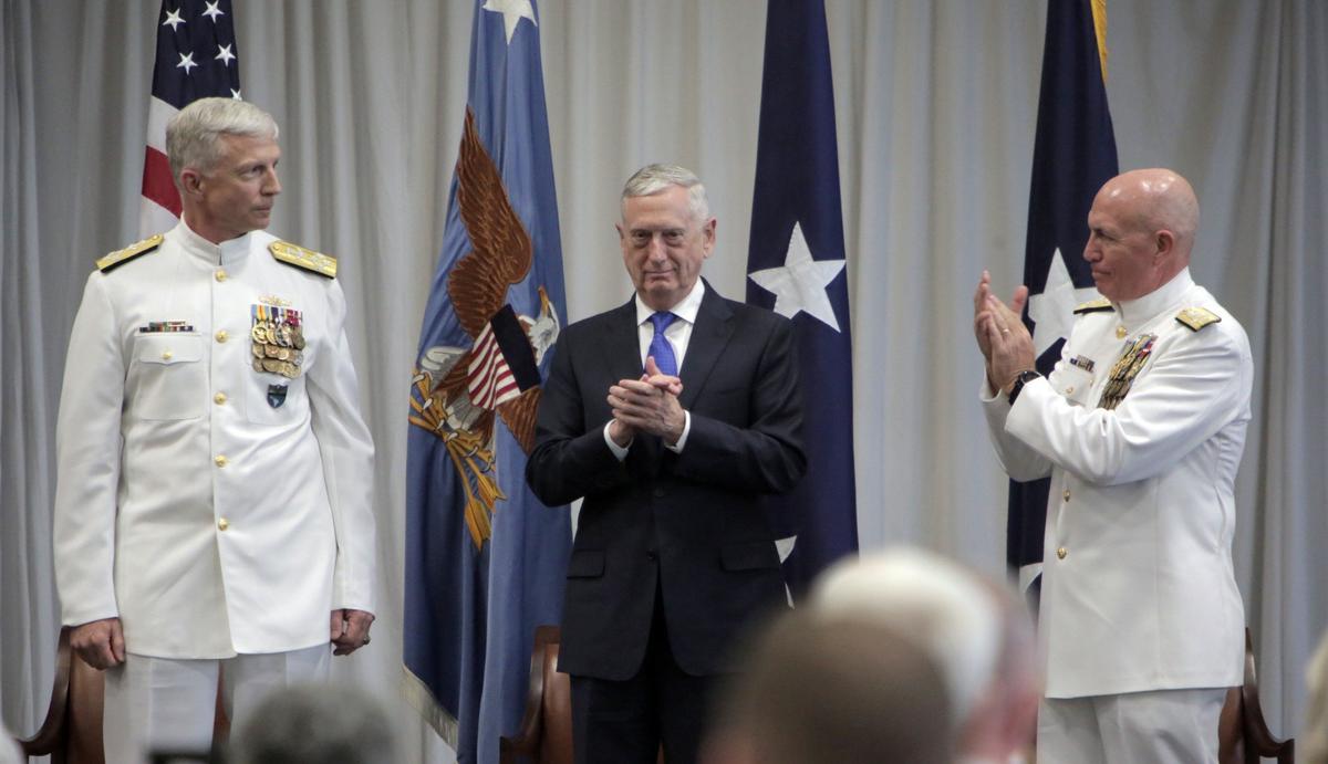 Navy Adm. Craig Faller, left, assumed command from U.S. Navy Adm. Kurt Tidd, right, of the Doral-based U.S. Southern Command on Monday.  U.S. Secretary of Defense James Mattis, center, presided over the ceremony.
