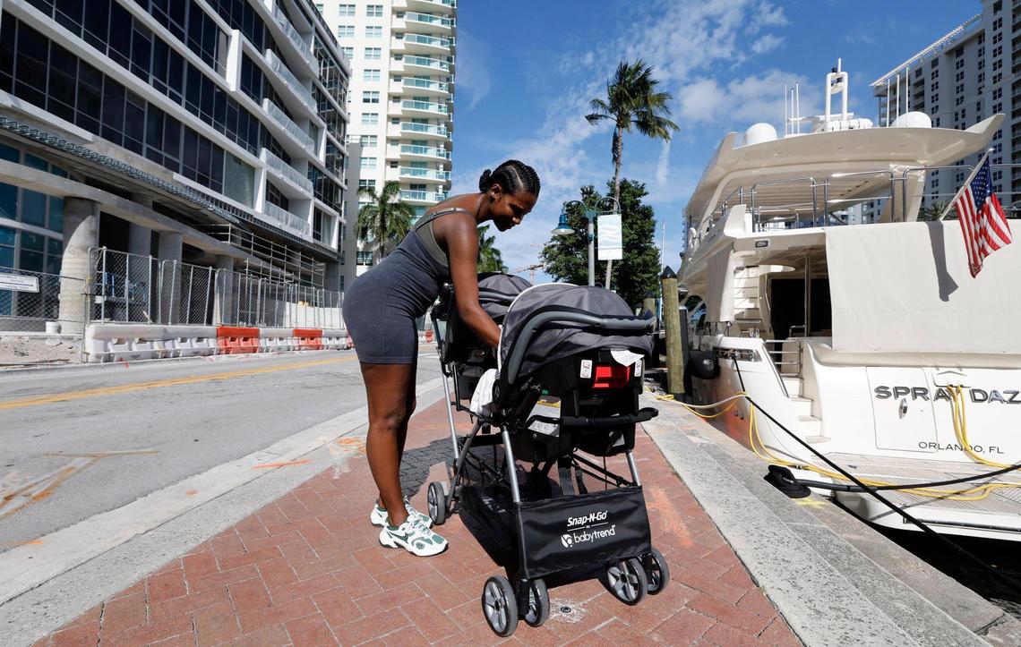 Downtown resident Jayme Callahan, 40, tends to her twin girls, Journey and Jayme, while on a stroll along the Fort Lauderdale Boardwalk on Thursday, April 24, 2025. There has been a dramatic increase in downtown Fort Lauderdale’s population of families with young children in recent years.