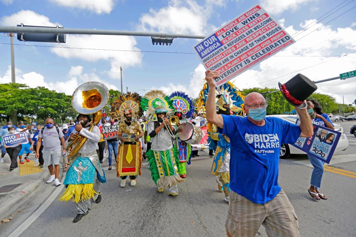 Bahamian Junkanoo perform as people marching during the Souls to the Polls in the last day of early voting as part of one of many events prior to the general elections outside the Joseph Caleb Center on Sunday, November 1, 2020, in Miami. March begins at 1:00 pm from the African Heritage Cultural Arts Center 6161 NW 22nd Ave., Miami, FL 33142 Voters will March to the Joseph Caleb Center 5400 N.W. 22nd Ave., Miami, FL 33142 for a Rally and to VOTE!