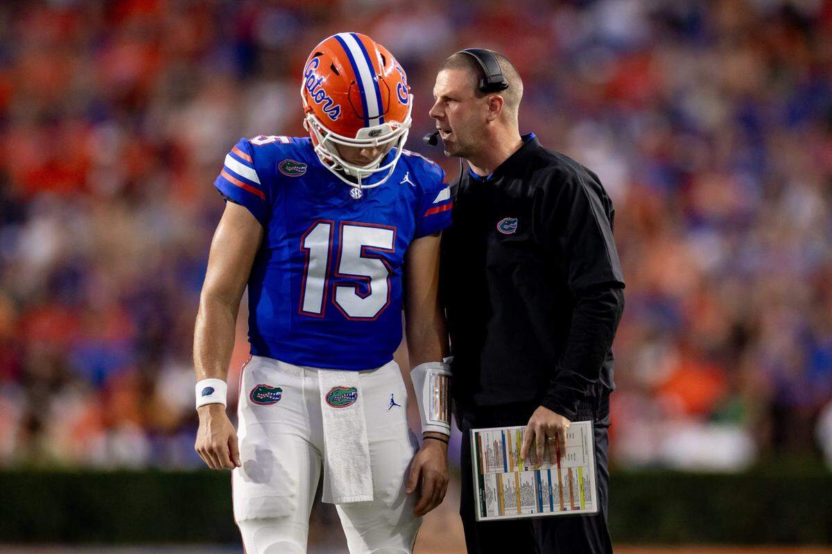 Florida Gators head coach Billy Napier and Florida Gators quarterback Graham Mertz (15) talk during a timeout during the first half against the Charlotte 49ers at Steve Spurrier Field at Ben Hill Griffin Stadium in Gainesville, FL on Saturday, September 23, 2023. [Matt Pendleton/Gainesville Sun]
