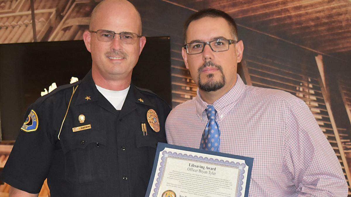 Key West Police Chief Sean Brandenburg honors Officer Bryan Tyler with the department’s Life Saving Award on Friday, Jan. 18, 2019.