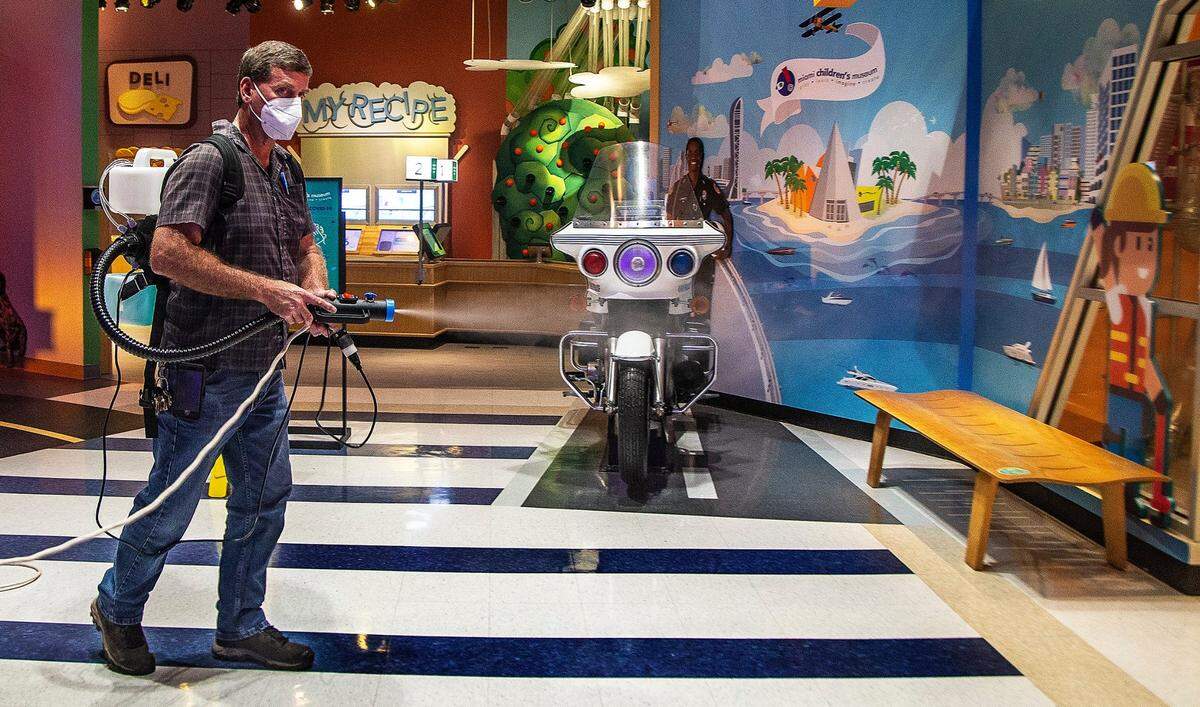 Staff member John Laurence uses a fogger disinfecting machine to sanitize different areas at the Miami Children’s Museum on Tuesday, April 27, 2021.