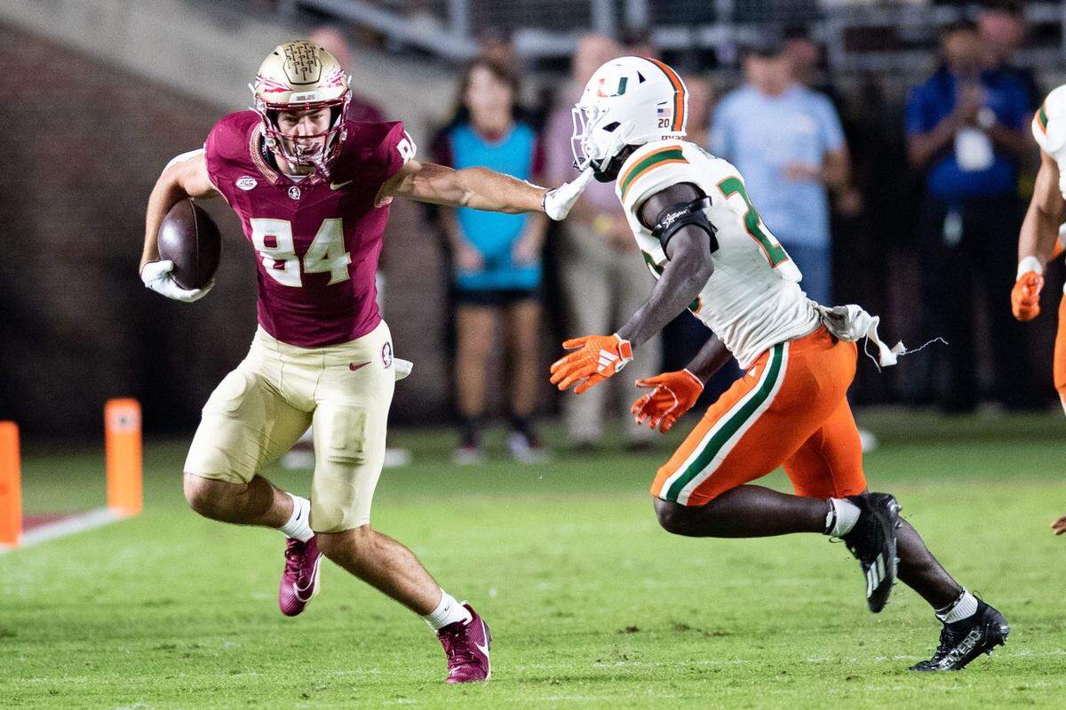 Florida State Seminoles tight end Kyle Morlock (84) pushes back a defender. The Florida State Seminoles defeated the Miami Hurricanes 27-20 on Saturday, Nov. 11, 2023.