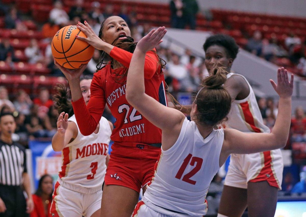 Westminster Academy’s Taelyn Carey (22) takes a shot as Cardinal Mooney’s Olivia Davis (12) defends in a Class 3A girls basketball state championship at the RP Funding Center in Lakeland on Friday, February 25, 2022.