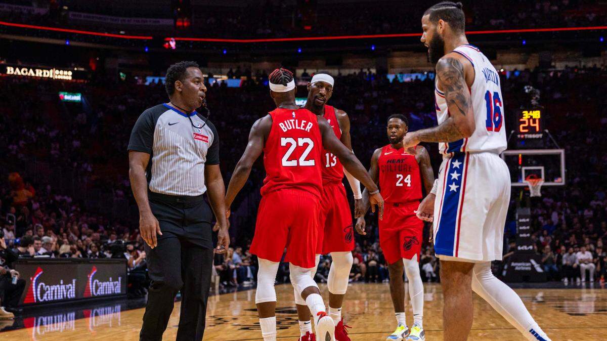 Miami Heat forward Jimmy Butler (22) and teammate Bam Adebayo (13) react to a foul as Philadelphia 76ers forward Caleb Martin (16) complains to a referee during the first half of an NBA game at Kaseya Center on Nov. 18, 2024, in Miami.