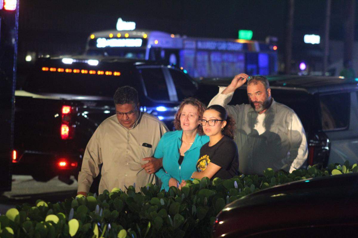 A man gunned down a woman and three children, injuring another child, before shooting himself Wednesday night at an apartment in Pembroke Park, March 26, 2025.An unidentified woman (center left, wearing a teal shirt) ran onto the crime scene screaming, “That’s my daughter.” He survived.