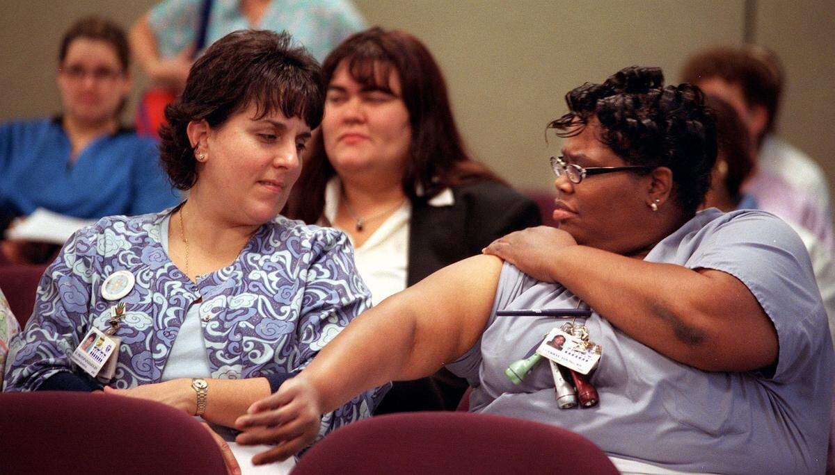 In January 2003, two registered nurses at Jackson Memorial Hospital’s children’s hospital center attend a seminar for employees of the University of Miami and Jackson Memorial Medical Center who might have needed to get the smallpox vaccine. The nurse at right was checking to see which of her arms had her previous smallpox scar. At the time, post-9/11, healthcare and public health workers were being vaccinated so that they could protect others in the event of a smallpox outbreak given some concerns that there could be a bioterrorist attack using smallpox as a weapon, the New York Health Department said.