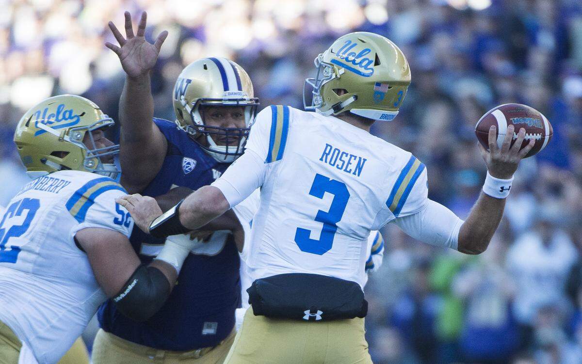 UCLA quarterback Josh Rosen passes while defended by Washington defensive lineman Vita Vea. The Washington Huskies played the UCLA Bruins in a NCAA football game at Husky Stadium in Seattle, Wash., on Saturday, Oct. 28, 2017.