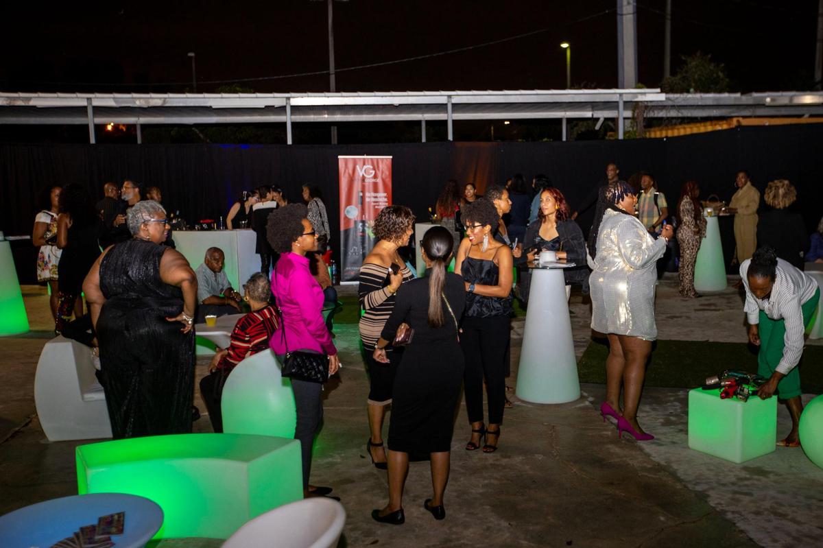 People socialize during the Preview for The Art of Transformation event at The ARC and Logan Building in Opa-locka, Florida, on Wednesday, November 30, 2022. The event is a five-day, three-block Mecca of African and Haitian art fair coinciding with Art Basel Miami Beach 2022 and just one of over 40 ‘exhibits’ part of 2022 Art of Black Miami.