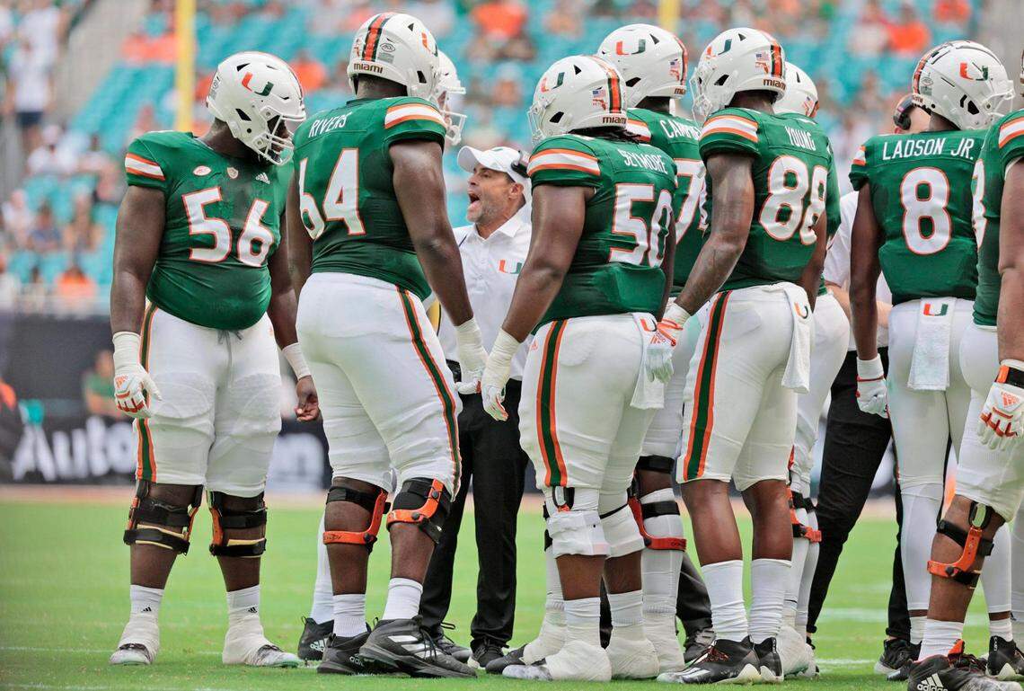 Miami Hurricanes assistant head coach and offensive line coach, Alex Mirabal speaks with offensive team players during game against the Duke Blue Devils at Hard Rock Stadium in Miami Gardens on Saturday, October 22, 2022.