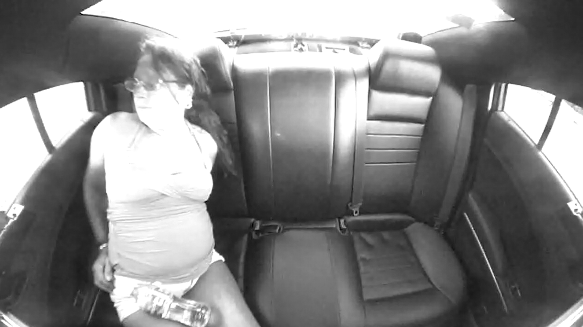 Diane Maria Hawk, seen here in handcuffs in the backseat of a police vehicle, was arrested Saturday, July 31, 2022 after she drove a golf cart with a Jack Daniel’s bottle inside her bag on Interstate 95 in Brevard County, according to Florida Highway Patrol.