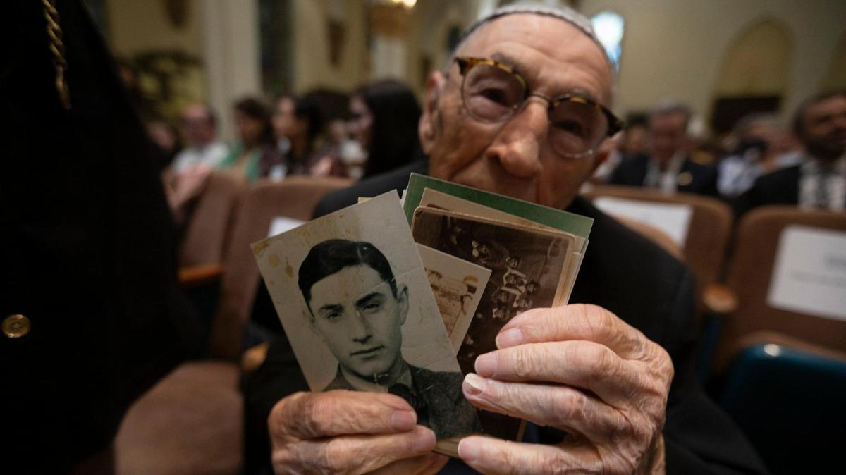 Jack Waksal, a Holocaust survivor, shares photographs from his youth during a community commemoration of Kristallnacht, or the Night of Broken Glass, at the Temple Israel of Greater Miami on November 10, 2024.