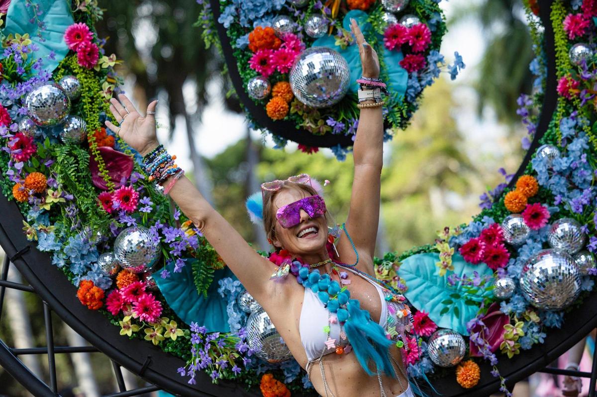 Joelle Bridges throws her hands up in front of a decorated Ultra Music logo at Bayfront Park, in Miami, Florida, on Friday, March 28, 2025.
