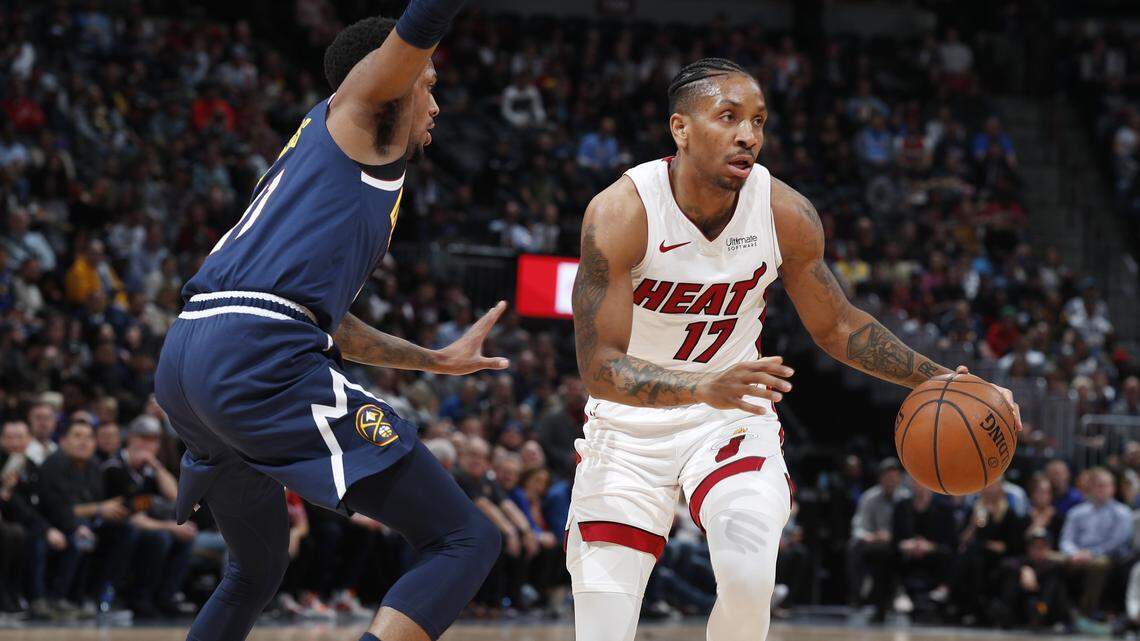 Miami Heat forward Rodney McGruder, right, drives past Denver Nuggets guard Malik Beasley in the first half of an NBA basketball game Monday, Feb. 11, 2019, in Denver. (AP Photo/David Zalubowski)