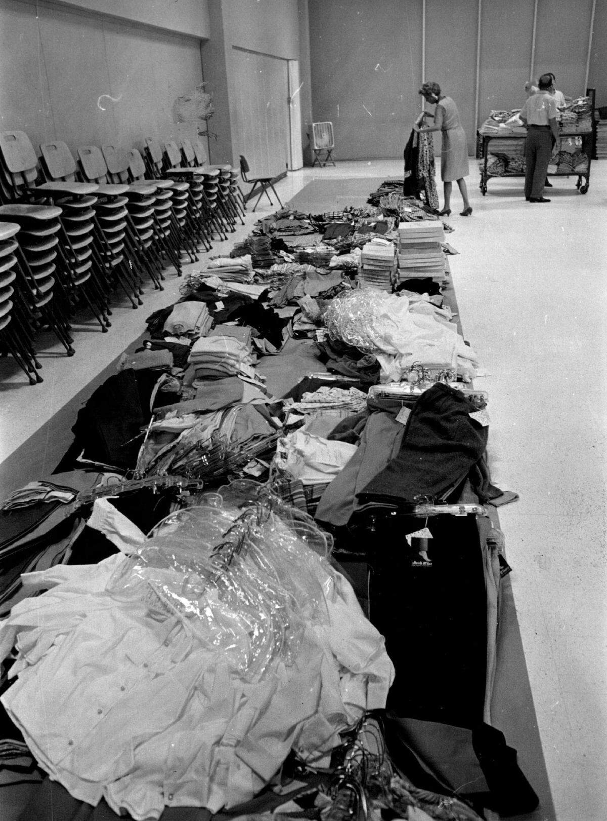 In the Jordan Marsh auditorium in Miami, workers sort out clothes after Hurricane Betsy