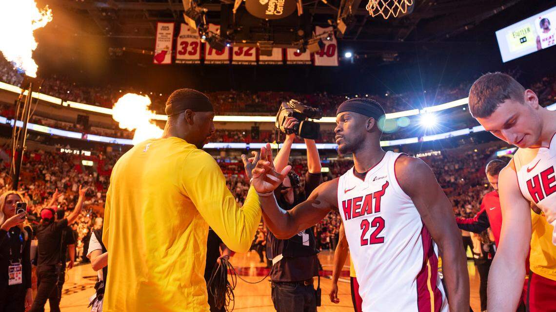 Miami Heat forward Jimmy Butler (22) and center Bam Adebayo (13) react during their introduction ceremony before playing against the Portland Trail Blazers in their NBA game at Kaseya Center on March 29, 2024 in Miami.