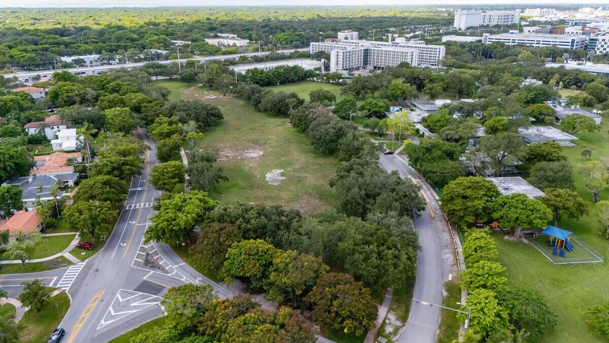 An aerial view of the green grassy area across from Henry S. West Laboratory School at 5300 Carillo Street in Coral Gables, Florida on Tuesday, June 30, 2026. The future Centennial Park owned by the University of Miami, is gifting the land to the city as part of a new development agreement.
