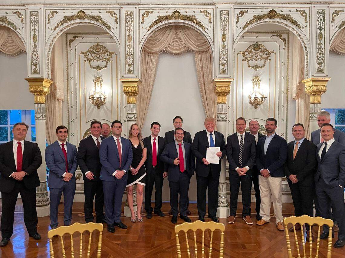 Donald Trump stands with Trump Media’s Truth Social investors and supporters at Mar-a-Lago in 2021, including Patrick Orlando and Andrew Dean Litinsky to Trump’s left and Wes Moss and William Wilkerson, standing behind Donald Trump Jr., to Trump’s right.