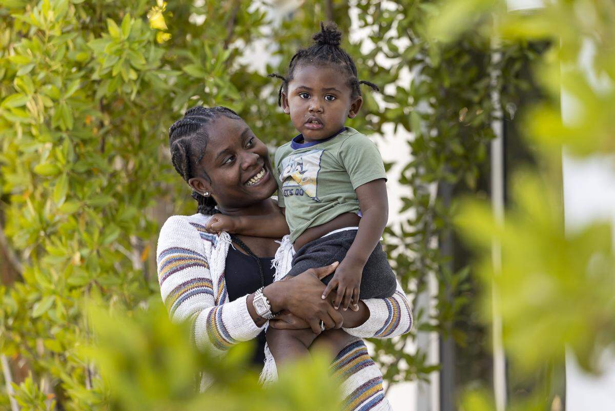 Nathalia Hall, 18, holds her son, Rhylan Hall, 2, near the Lotus House Women's Shelter on Tuesday, Nov. 18, 2025, in Miami, Fla.