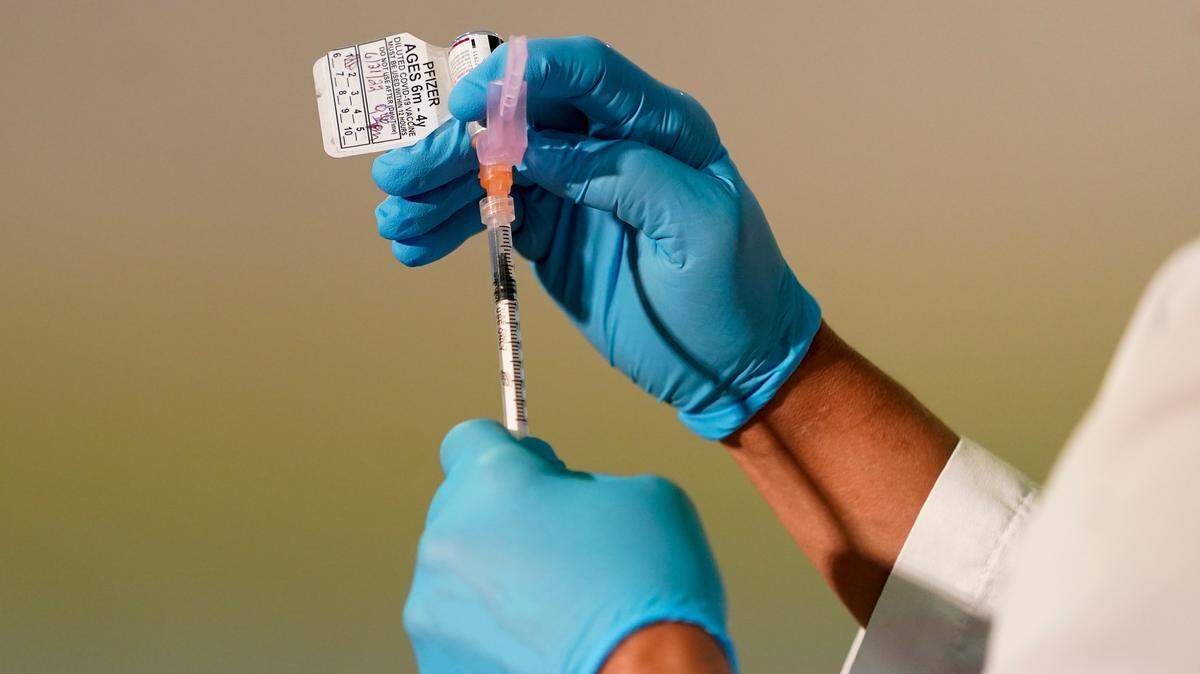 A registered nurse prepares a dose of the Pfizer COVID-19 vaccine for children 6 months through 4 years old on Tuesday, June 21, 2022, at Montefiore Medical Group in the Bronx borough of New York.