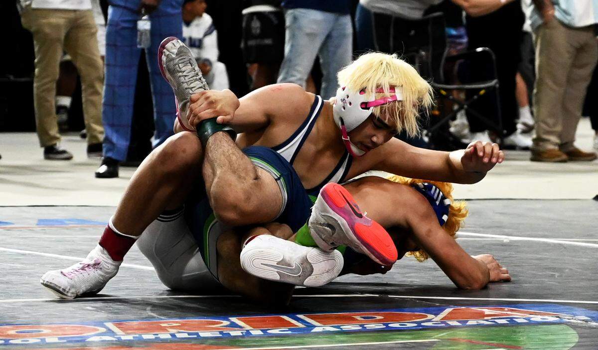 Keagan Mesina gets the upper hand in the Class 1A 120-pound state title match he eventually won on Saturday at the FHSAA IBT wrestling state championships at Silver Spurs Arena in Kissimmee.