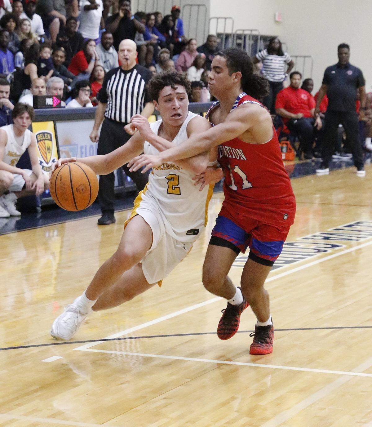 Belen Jesuit Wolverines Lukas Diaz (2) slides around Plantation Colonels Nate Rey during the Region 4-5A semifinal boys basketball game on Saturday, February 21, 2026 at Belen Jesuit in Miami. Andrew Uloza / for Miami Herald