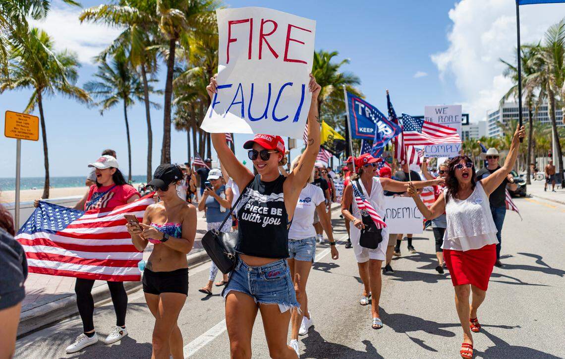 Kier Mellour, center, participates in an ÒEnd Of The Pandemic March South FloridaÓ rally in Las Olas Beach in Fort Lauderdale, Florida on Saturday, August 15, 2020.