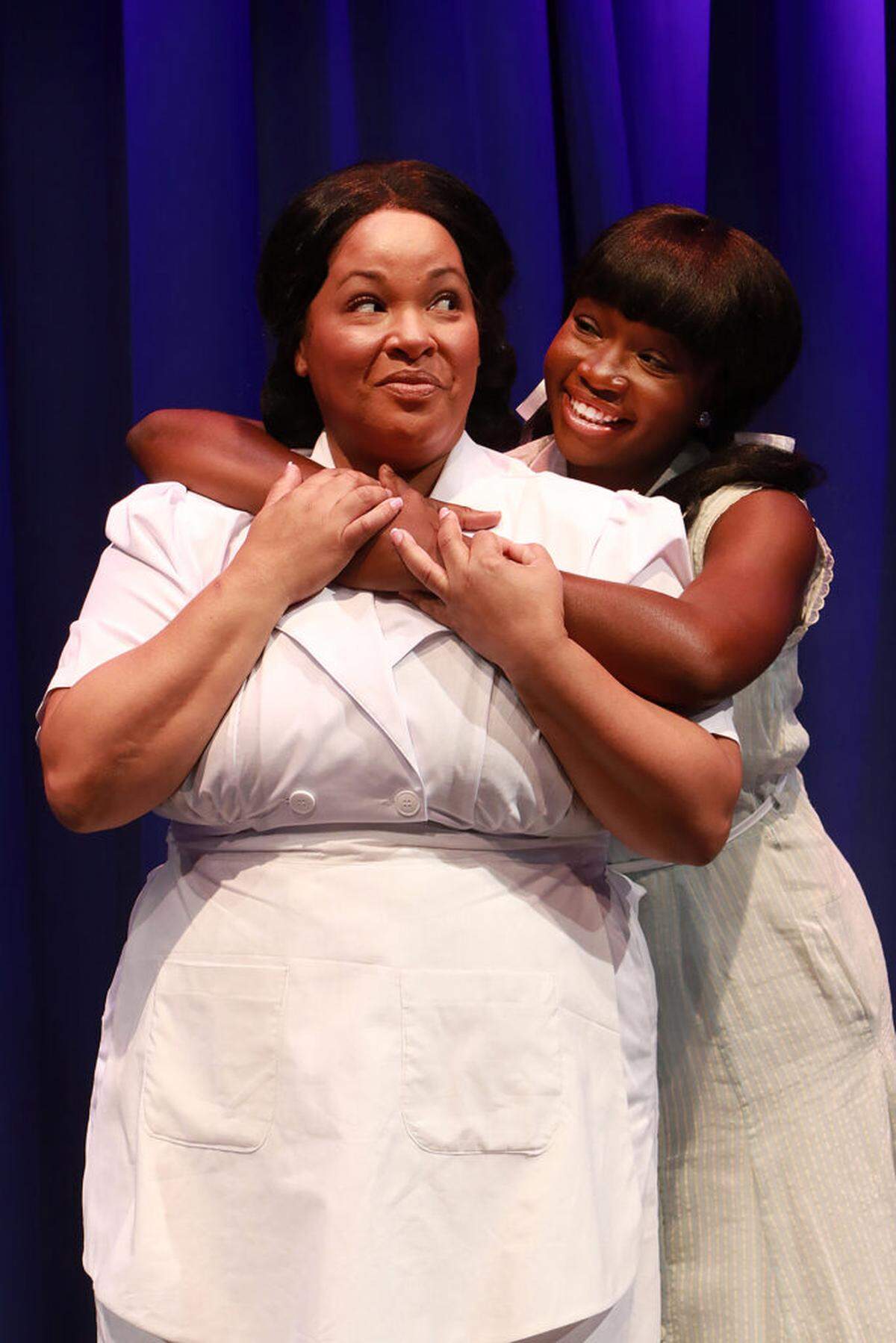 Kareema Khouri as Caroline gets a hug from Cassidy Joseph as her activist daughter Emmie in the Actors’ Playhouse production of “Caroline, or Change.”