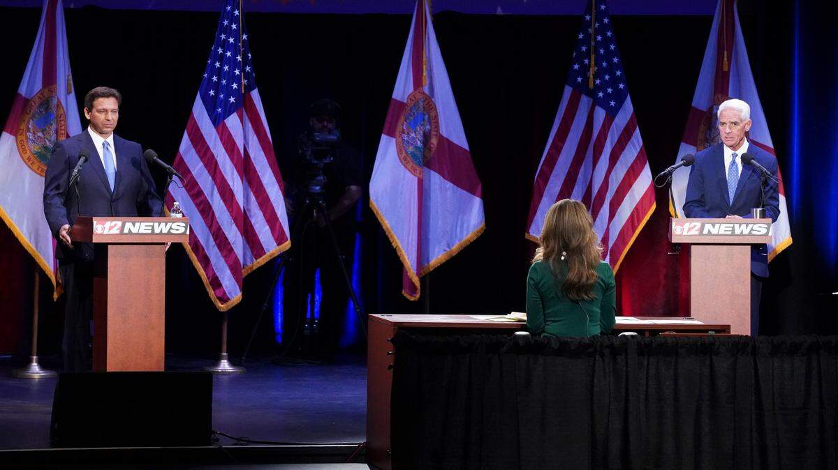 Republican Gov. Ron DeSantis, left, and former Gov. Charlie Crist, D-Fla., participate in a debate at the Sunrise Theatre, Monday, Oct. 24, 2022, in Fort Pierce, Fla.