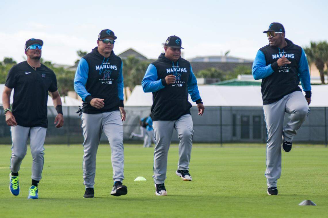 Miami Marlins shortstop Miguel Rojas (from left), outfielder Avisail Garcia, utility player Willians Astudillo and first baseman Jesus Aguilar stretch prior to a spring training workout on Tuesday, March 22, 2022, in Jupiter, Florida.