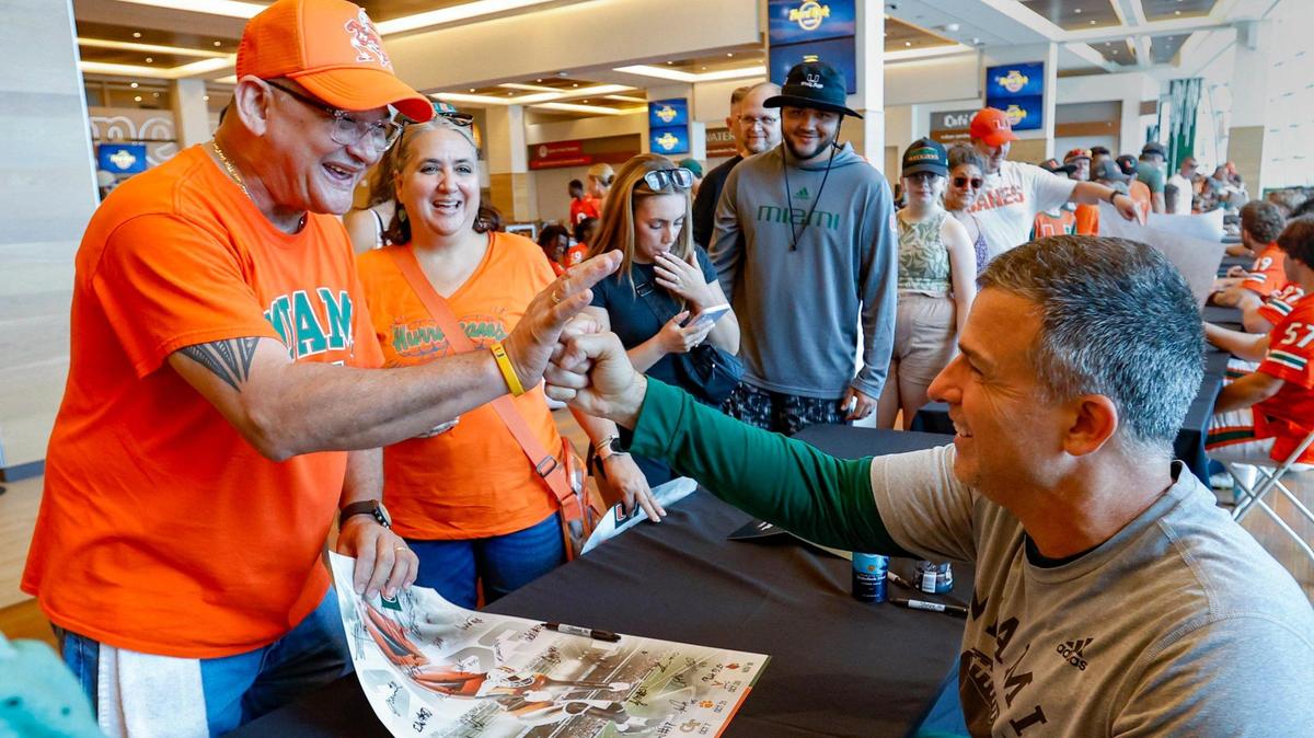 Miami Hurricanes coach Mario Cristobal fist pumps Enrique Borregales, father of Miami Hurricanes place kicker Andres Borregales (30), during the University of Miami’s annual CanesFest at Hard Rock Stadium in Miami Gardens on Saturday, August 12, 2023.