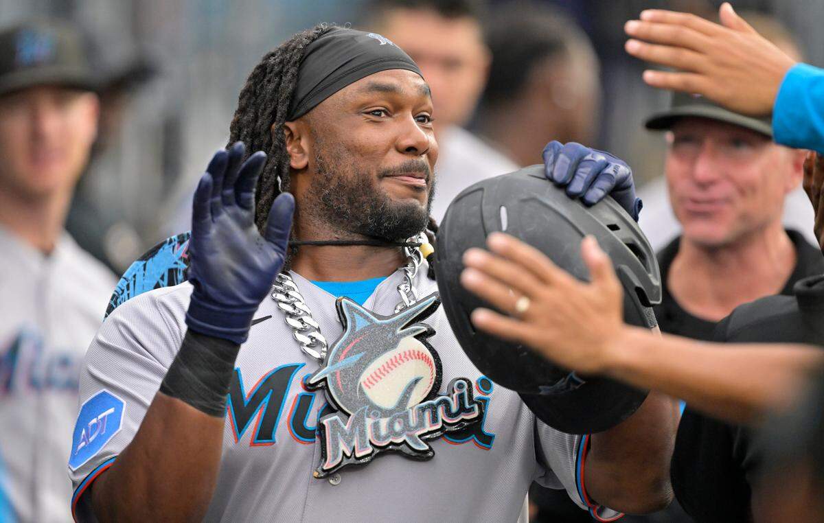Aug 19, 2023; Los Angeles, California, USA; Miami Marlins designated hitter Josh Bell (9) is congratulated in the dugout after hitting a solo home run in the first inning against the Los Angeles Dodgers at Dodger Stadium. Mandatory Credit: Jayne Kamin-Oncea-USA TODAY Sports