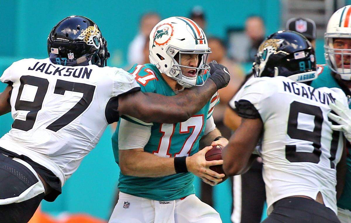 Dolphins quarterback Ryan Tannehill (17) is sacked by Malik Jackson (97) of the Jaguars in a game on December 23, 2018 at Hard Rock Stadium in Miami Gardens, Florida.