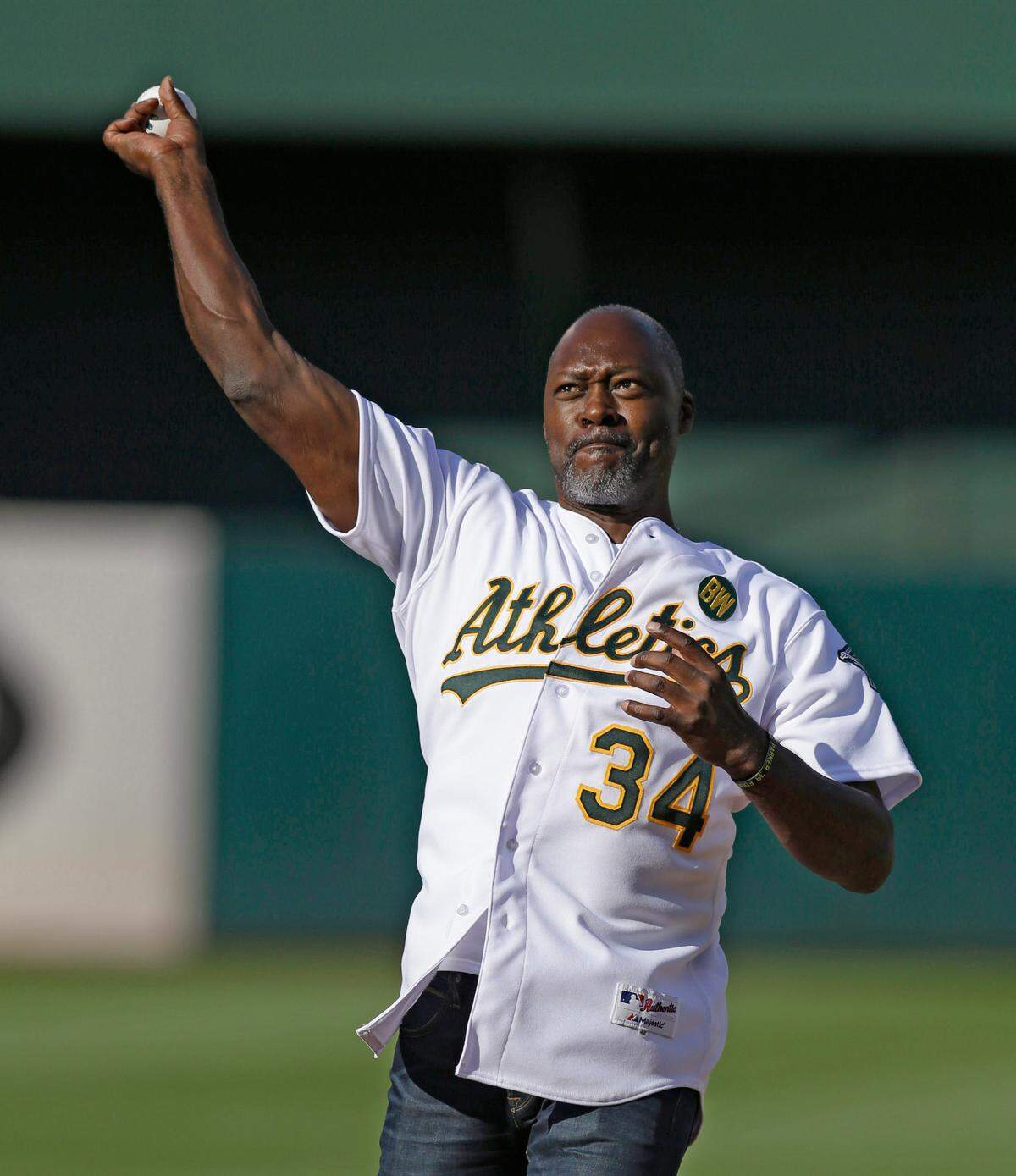 FILE - In this July 19, 2014, file photo, former Oakland Athletics’ Dave Stewart throws out the ceremonial first pitch during a pre-game ceremony honoring the reunion of players from the 1989 world championship team prior to a baseball game against the Baltimore Orioles in Oakland, Calif. The Arizona Diamondbacks announced Thursday, Sept. 25, 2014, that Stewart will be the franchise’s vice president and general manager. (AP Photo/Ben Margot, File)