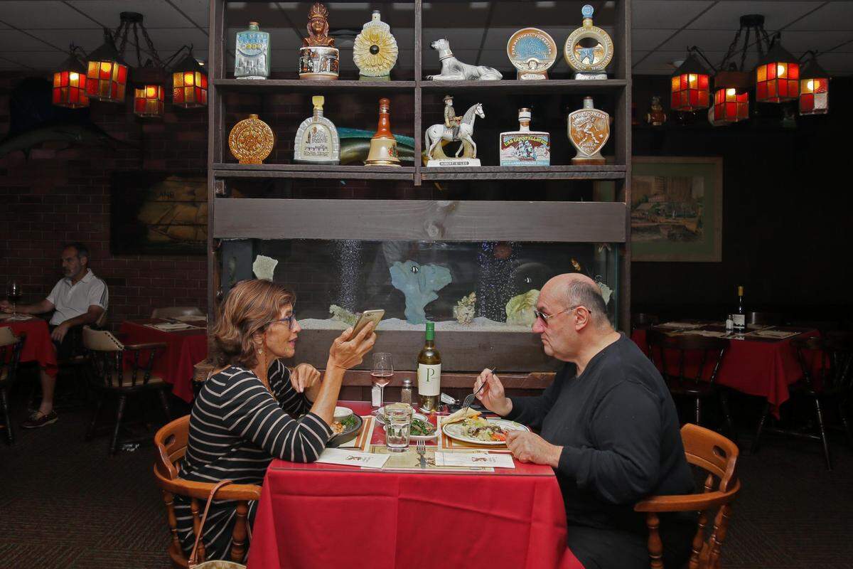 Beatriz Vasquez, 60, and Jay Vargas, 65, two longtime customers, enjoy lunch at Captain’s Tavern Restaurant on Aug. 10, 2019. The seafood restaurant has been in business for almost 50 years.