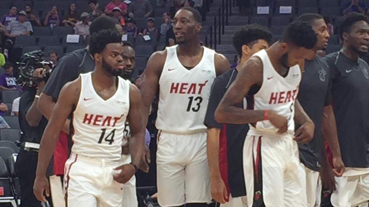 The Miami Heat's summer league team featuring center Bam Adebayo (#13), guard Derrick Walton Jr. (#14) and forward Derrick Jones (#5) prepares to take the floor against the Golden State Warriors at the Golden 1 Center in Sacramento, Calif. July 2, 2018.