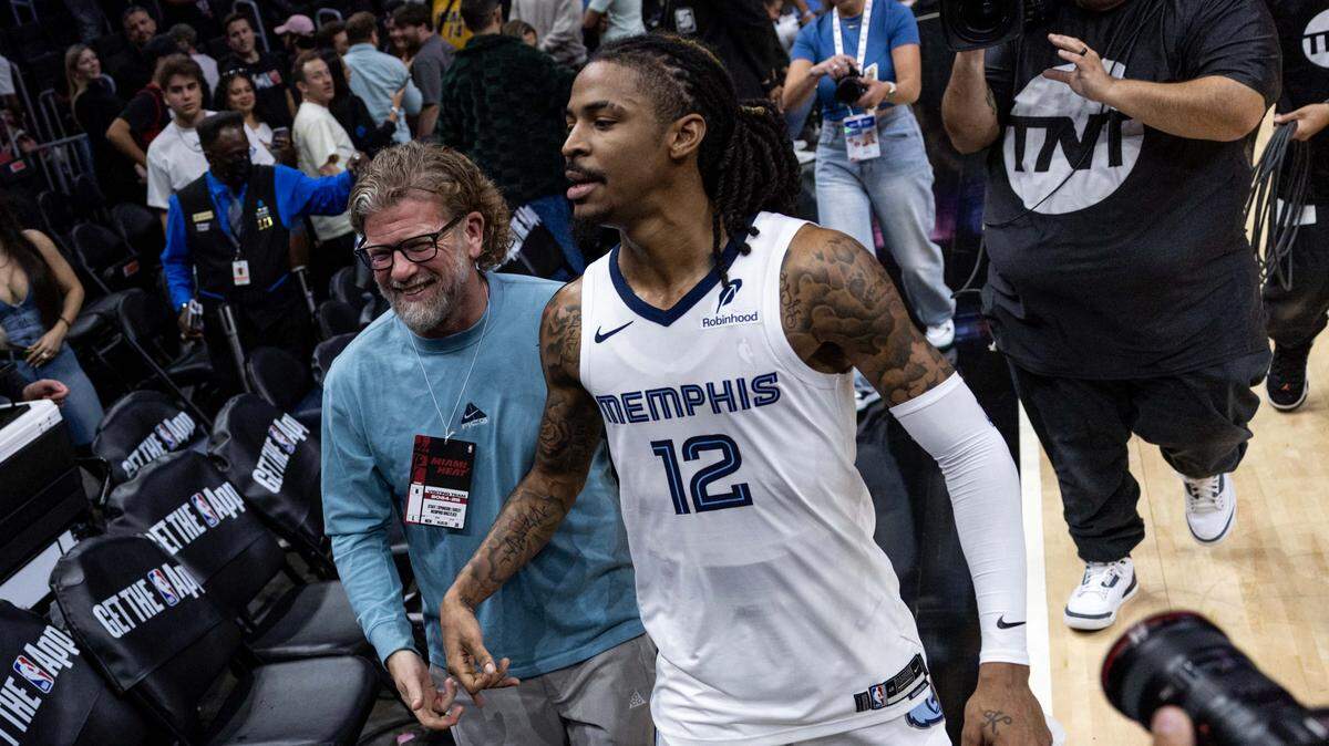 Memphis Grizzlies guard Ja Morant (12) walks off the court after he hit a game-winning buzzer beater to defeat the Heat 110-108 during the second half of an NBA game at Kaseya Center on April 3, 2025, in Miami.
