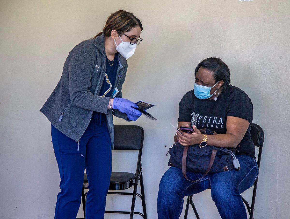 An FIU medical student checks on Miami Garden resident Trika Gerard after she got vaccinated at a Miami-Dade County mobile vaccination unit administering doses of the Pfizer vaccine at South Miami Children’s Clinic on Saturday, March 20, 2021.