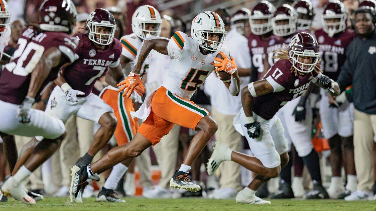Miami Hurricanes wide receiver Jacolby George (15) earns a first down as the Texas A&M Aggies give chase in the third quarter at Kyle Field, Bryan College Station, Texas on Saturday, September 17, 2022.