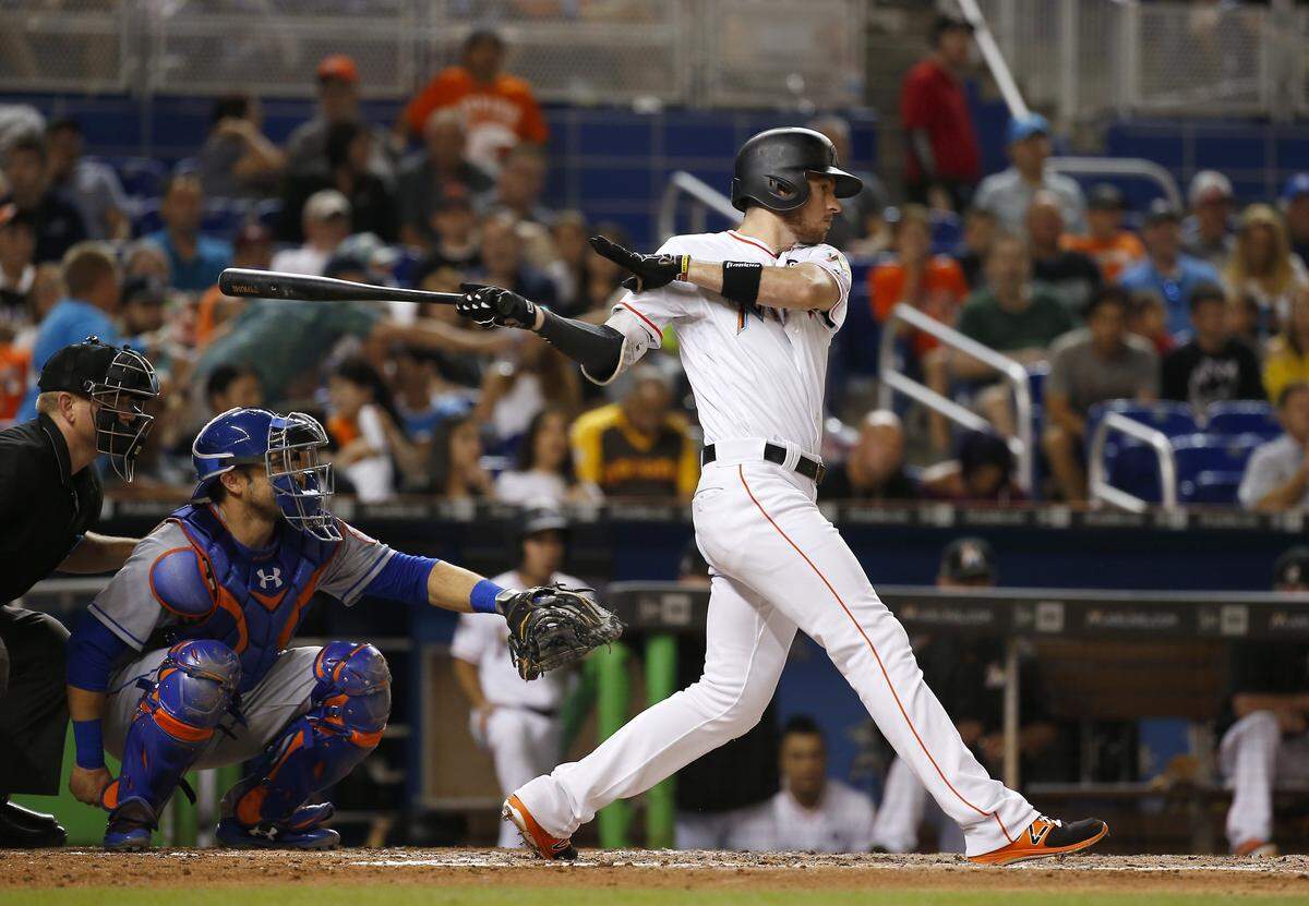 Miami Marlins shortstop J.T. Riddle hits a single during the third inning of a baseball game against the New York Mets at Marlins Park on Wednesday, June 28, 2017 in Miami.