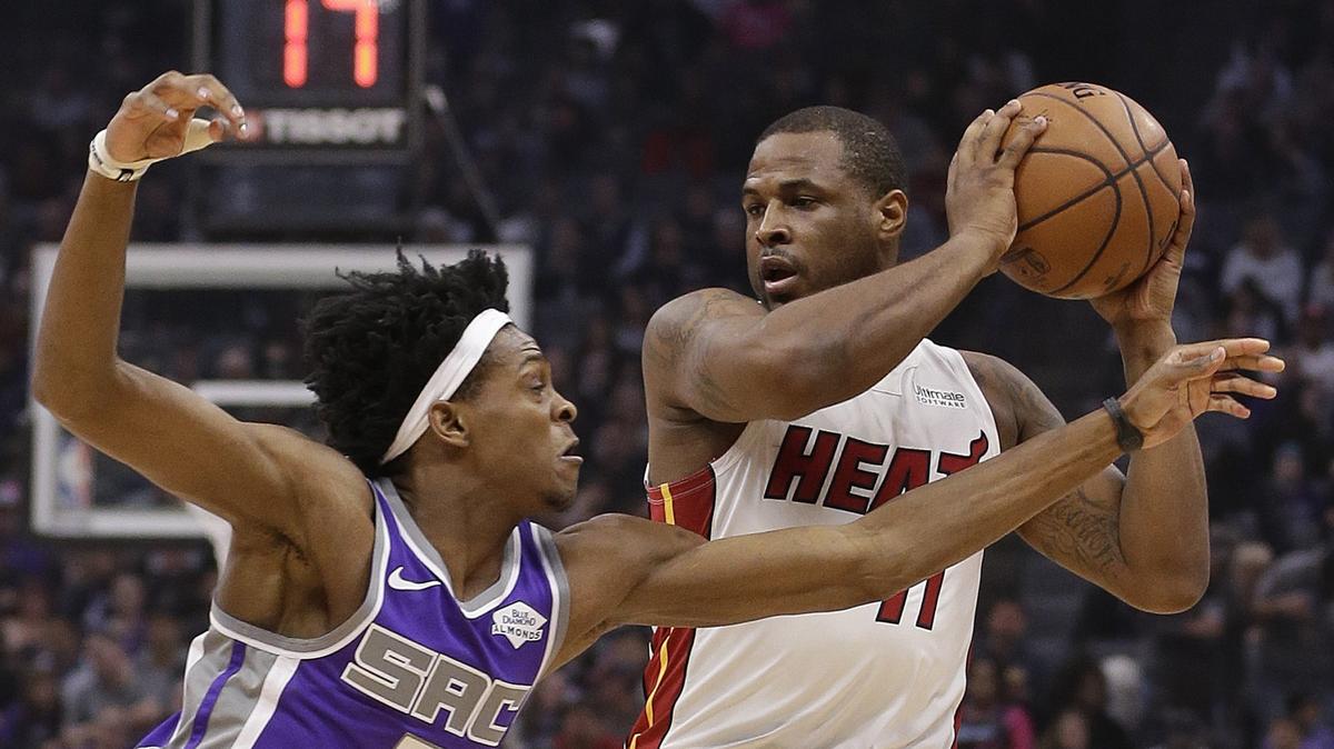 Miami Heat guard Dion Waiters, right, keeps the ball out of the reach of Sacramento Kings guard De’Aaron Fox during the first quarter of an NBA basketball game Friday, Feb. 8, 2019, in Sacramento, Calif.