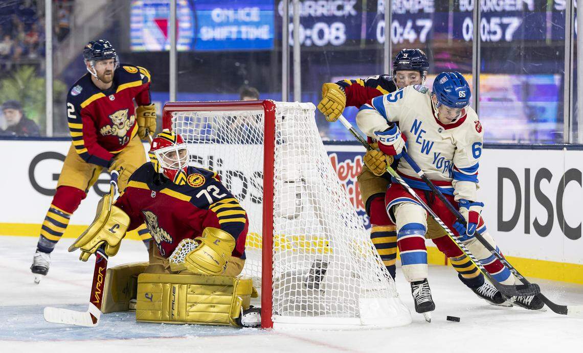 Florida Panthers goaltender Sergei Bobrovsky (72) watches center Sam Bennett (9) defend as New York Rangers left wing Brett Berard (65) tries to score in the second period of their Winter Classic outdoor hockey game at loanDepot park on Friday, Jan. 2, 2026, in Miami, Fla.