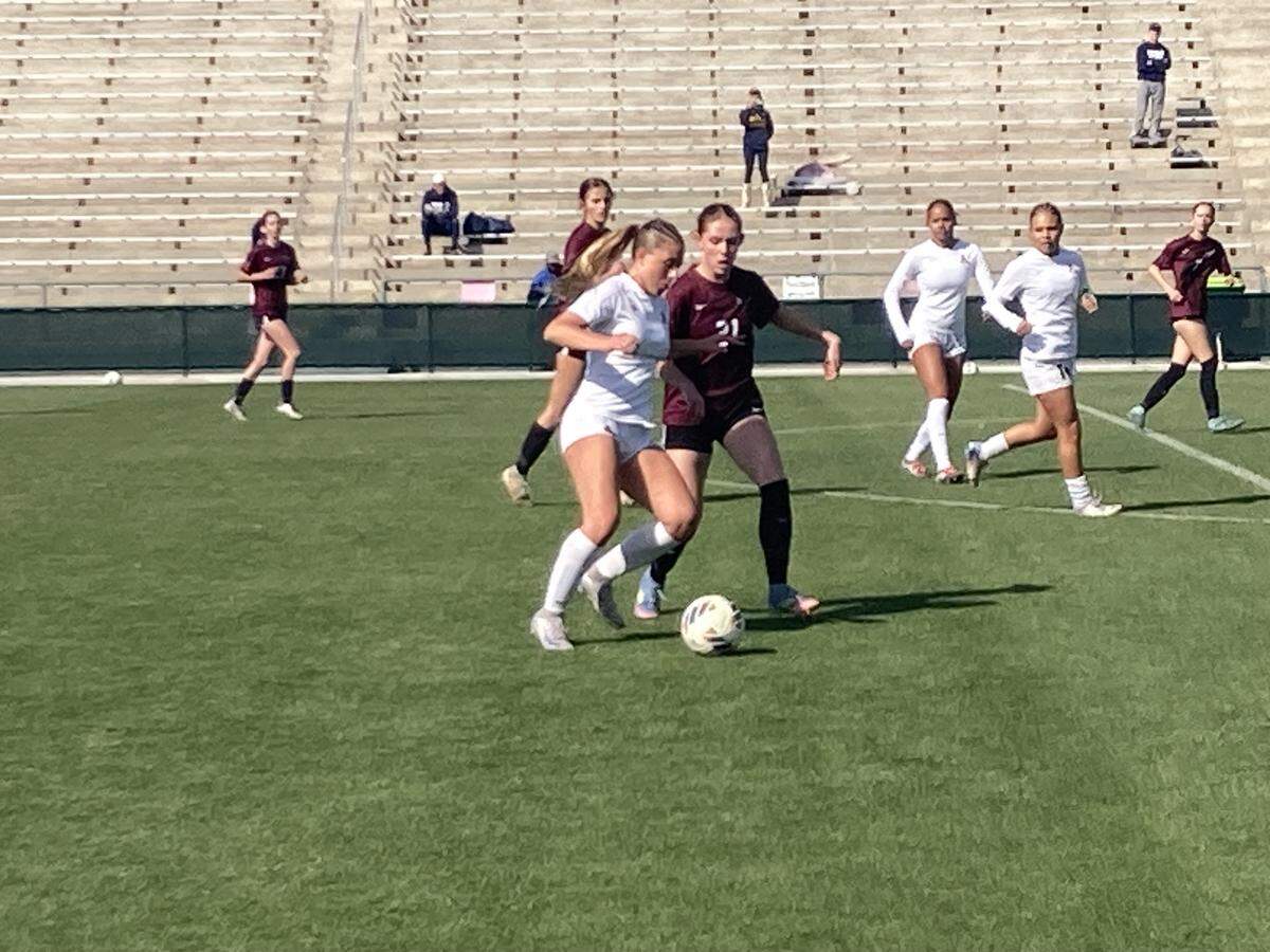 St. Thomas Aquinas’ Madison McKeon (white jersey) battles a Niceville defender for the ball during Wednesday’s Class 6A state semifinal at Spec Martin Stadium in DeLand, Fla.