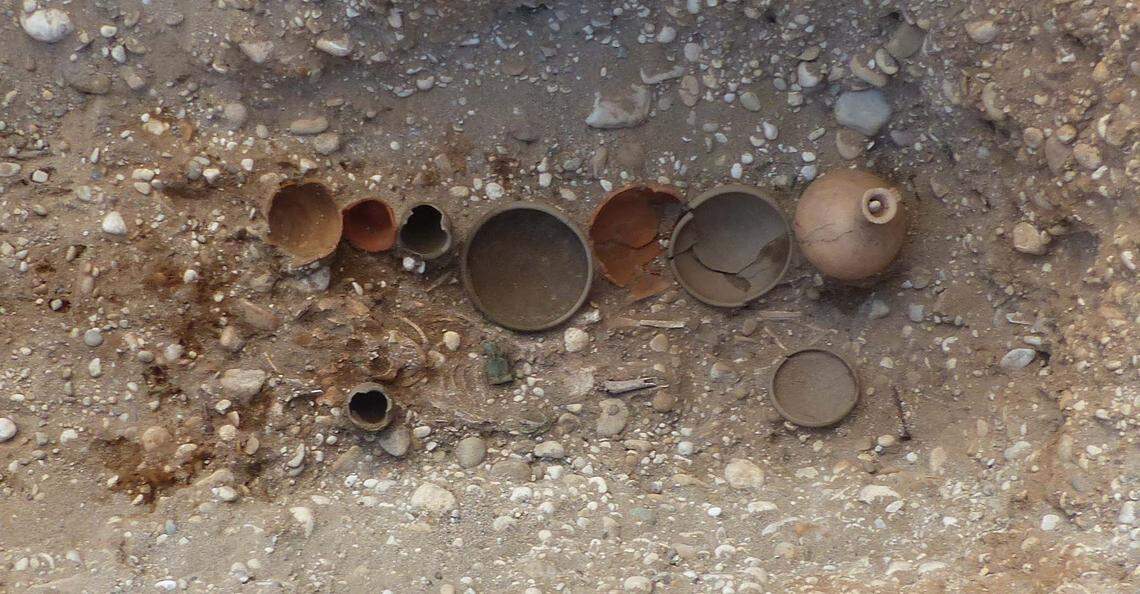 A collection of ceramics, coins, bracelets and food deposits buried alongside a child between the ages of one and six.