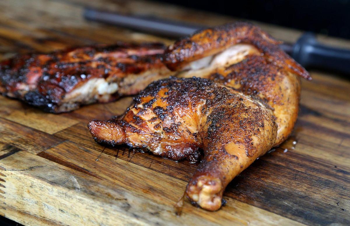 Spice rubbed chicken, from the menu of the recently opened pop-up barbecue spot the Drinking Pig, is smoked for hours with Caribbean flavors.