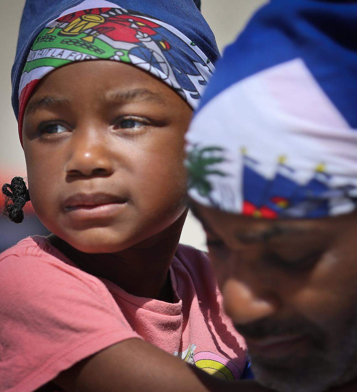 Adalee Belizaire, 4, holds on the her father, Adaley Belizaire, while the pair attend the rally as the Family Action Network Movement (FANM), alongside South Florida partners, led a rally on Sunday, April 26, 2026, calling on federal decision-makers to extend Temporary Protected Status (TPS) for Haitian nationals at the MoCA Plaza in North Miami, Florida.  The mobilization comes at a critical moment as the Supreme Court of the United States prepares to hear oral arguments on the administration's attempt to terminate TPS for Haiti. The decision could place more than 350,000 Haitian nationals at risk of losing protection from deportation and work authorization, threatening the stability of their families. The April 26 event in North Miami is part of a broader series of pre-oral argument mobilizations, including actions in Atlanta on April 18 and in Washington, D.C., in front of the Supreme Court on April 29, coinciding with oral arguments. 