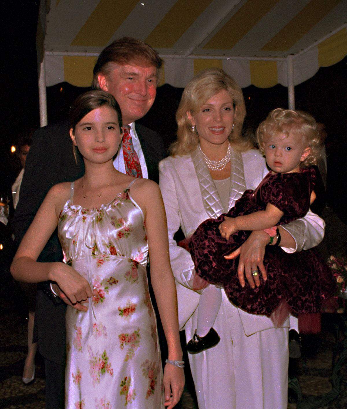 At a preview of the Club Mar-a-Lago for club members, Donald Trump, Marla and daughters (L) Ivanka (13) and Tiffany (1 1/2) pose for photos.