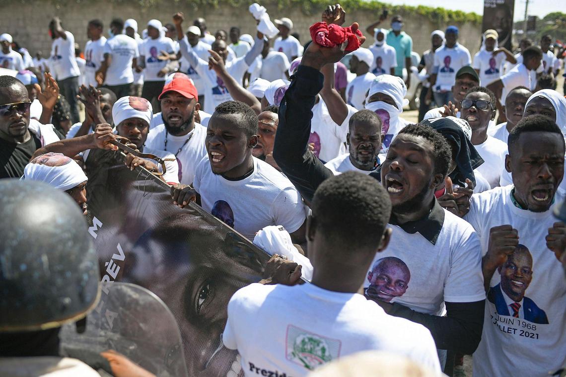 Supporters of slain Haitian President Jovenel Moise are blocked from attending Moise’s funeral outside his family home as they call for justice in Cap-Haitien, Haiti, Friday, July 23, 2021. Moise was assassinated at his home in Port-au-Prince on July 7.