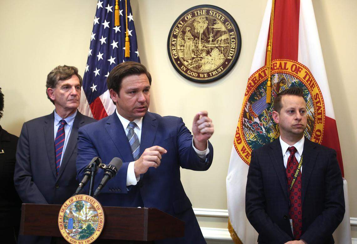 Florida Gov. Ron DeSantis, center, announces new measures to combat the spread of the coronavirus in Florida during a news conference in Tallahassee, Wednesday, March 11, 2020. On the left is Surgeon General Scott Rivkees and on the right is Jared Moskowitz, director of the Division of Emergency Management.
