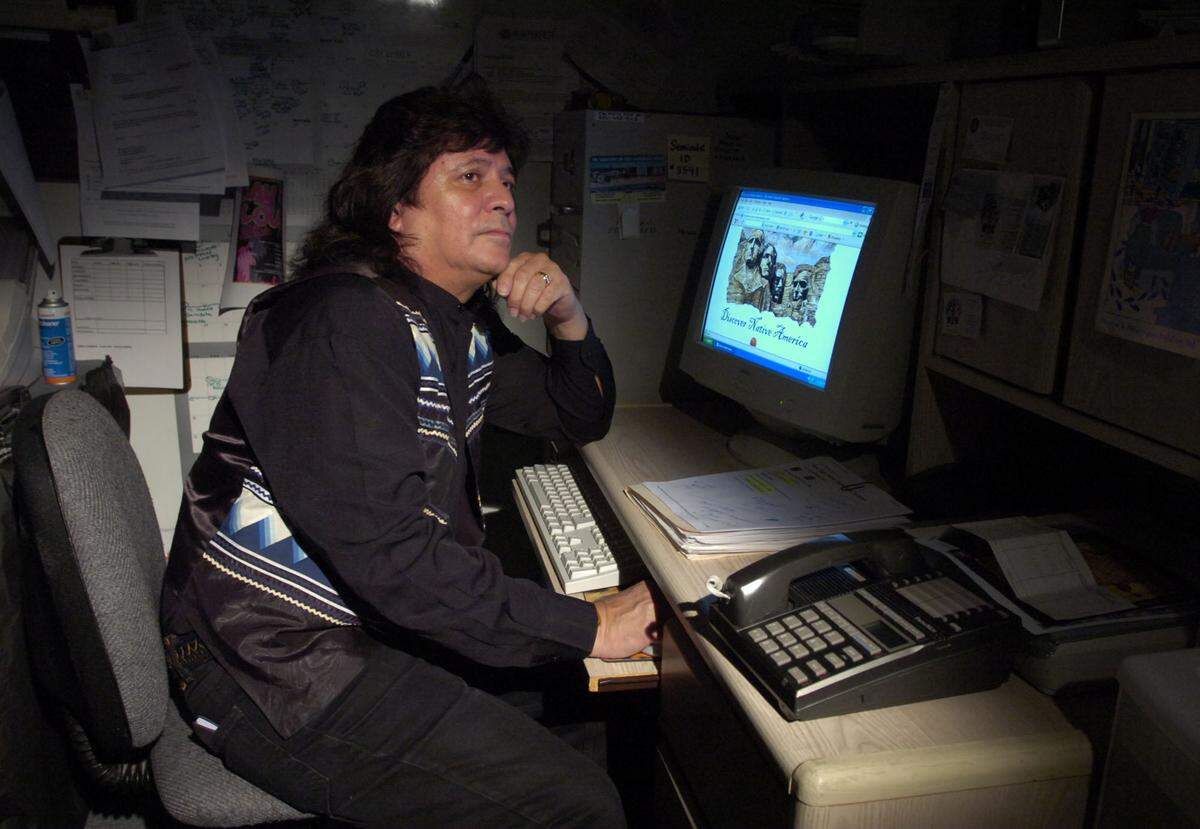 Native American Lee Tiger, at his Davie home on Nov. 24, 2006, works on a multiyear project developing a database to link all the tribes in the United States.